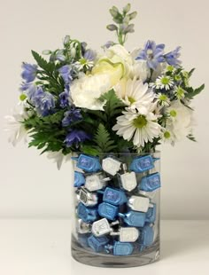 a vase filled with blue and white candy