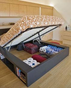 a bed with an open storage compartment underneath it