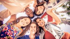 a group of young people standing in a circle