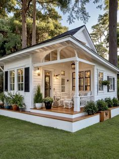 a white house with black shutters and porch