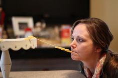 a woman sitting on a couch with a toothbrush in her mouth