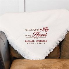 a personalized blanket on a chair that says always in my heart