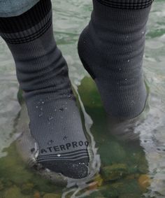 a person standing in the water wearing socks