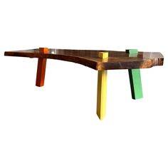 a wooden bench with multicolored sticks sticking out of it's back end