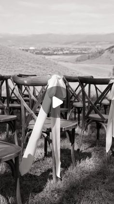 black and white photograph of wooden benches with ribbons tied to them