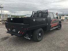 a black truck parked in a parking lot