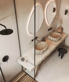 a bathroom with two sinks and mirrors on the wall