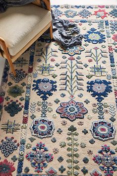 a chair and rug on the floor in a room