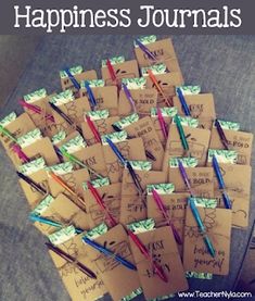 a pile of envelopes sitting on top of a table next to a cup filled with pens