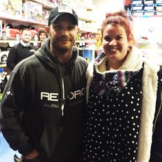 a man and woman standing next to each other in a store