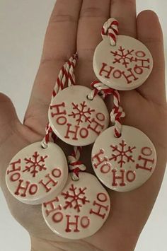 hand holding five christmas ornament ornaments with candy canes