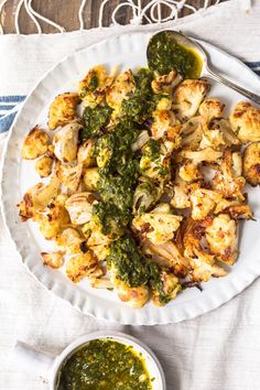 a white plate topped with cauliflower and pesto