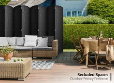 an outdoor privacy area with wicker furniture