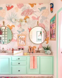 the bathroom is decorated in pastel colors and has two mirrors on the wall above the sink