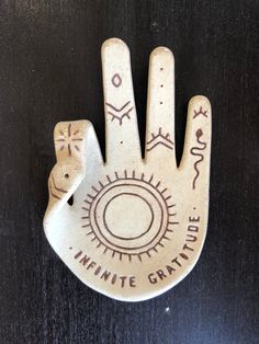 a ceramic hand with the words infinite grateful written on it