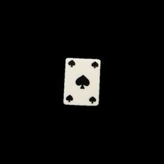 a white and black ace playing card against a black background