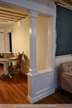 a living room and dining area with hard wood flooring in an unfinished home that is being renovated