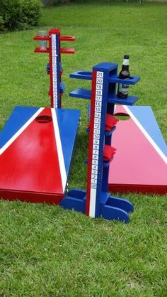 two red, white and blue boards in the grass