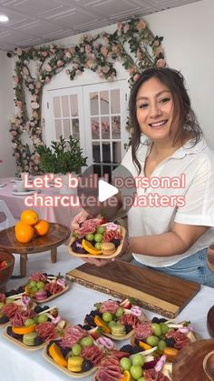 a woman standing in front of a table filled with food