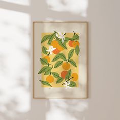 an orange print hangs on the wall next to a window