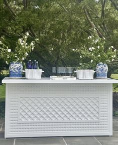 an outdoor bar with blue and white vases on it