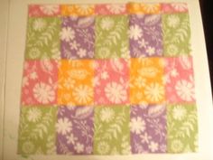 an image of a quilted square with flowers on it