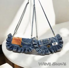 a pair of jeans purses hanging from a hook