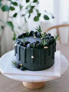 a chocolate cake with berries and pineapples on top