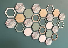 a group of hexagonal mirrors hanging on a wall next to a green wall