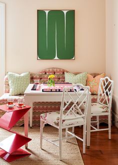 a living room filled with furniture and a painting on the wall