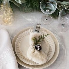 a place setting with pine cones and napkins