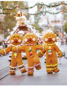 three gingerbread men are walking down the street