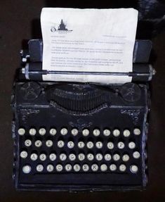 an old fashioned typewriter with paper on it