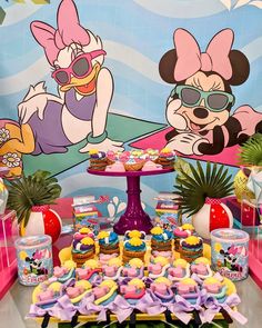 a table topped with lots of cupcakes and cakes