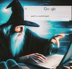 an old man with a long beard using a laptop while wearing a wizard's hat