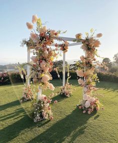 an outdoor wedding setup with flowers and greenery