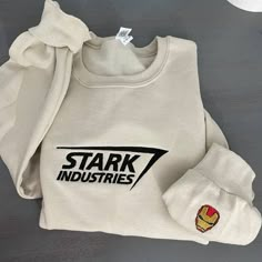 a white sweatshirt with the words stark industries on it and iron man's head