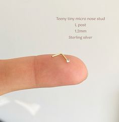 Please read before buying!  TEENY TINY CRYSTAL NOSE STUD * So tiny and sparkling  * L - shape post * Sold as single or pair  * Sterling silver - gold plated sterling silver  * Material stone: CRYSTAL - not real diamond  * Thickness post: 22 gauge/ 0.6mm (keep in mind that the post is thin and can be FLEXIBLE!) * Size crystal: 1.2mm  please note that size 1.2mm is super tiny  ------------------ * More from us: https://nahnym.etsy.com * IG: @Nahnym_ ----------------- MATERIALS GOLD-FILLED & STERLI Tiny Nose Studs, Diamond Nose Stud, Gold Nose Stud, Crystal Diamond, Nose Stud, Diamond Crystal, Real Diamonds, L Shape, Jewelry Plate