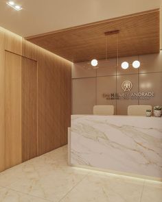 an office lobby with marble counter tops and wooden paneling on the walls, along with white chairs