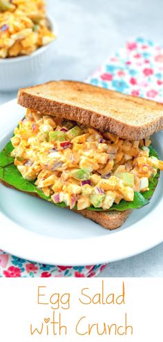 an egg salad sandwich on a white plate