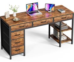 a computer desk with two laptops on it