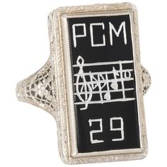 Finely detailed vintage Art Deco era ring (circa 1920s), crafted in 14 karat white gold. Onyx is inscribed 'PCM' along with a music sheet and the year '29' Lacy filigree mount with embossed floral detail, a hallmark of the Art Deco era. The ring is in excellent condition. Particulars: Weight: 3.3 grams Stones: Onyx is inscribed 'PCM' along with a music sheet and the year '29' Size & Measurements: The ring is a size 4 1/2 (sizable). The mount measures 21mm in length (0.82 inches) and 12mm wide (0 Cocktail Party Jewelry, Music Note Ring, Art Deco Rings, Vintage Cocktail Ring, Square Rings, Music Sheet, Valentines Jewelry, Art Deco Era, Vintage Music