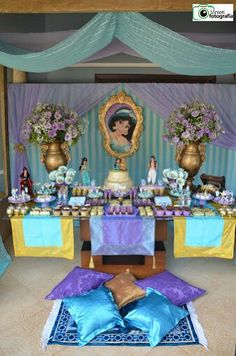 the table is set up with purple and blue decorations