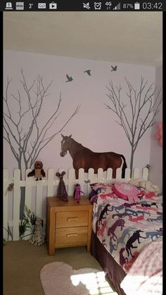 a bedroom with a horse painted on the wall next to a bed and dresser in front of it