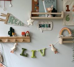 the wall is decorated with wooden shelves and toys for children's room decor, such as bookshelves