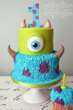 a birthday cake decorated with blue and green frosting