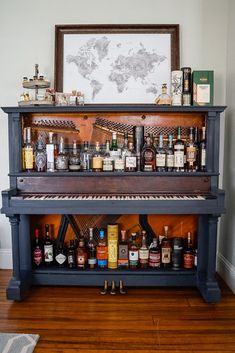 an old piano is filled with liquor bottles