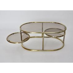 two round brass coffee tables with glass tops