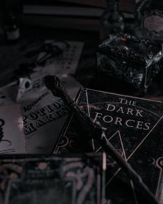 the dark forces book is laying on top of other books