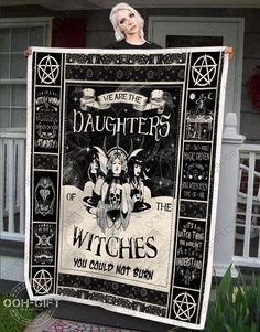 a woman holding up a black and white blanket with the words, witches you could not burn